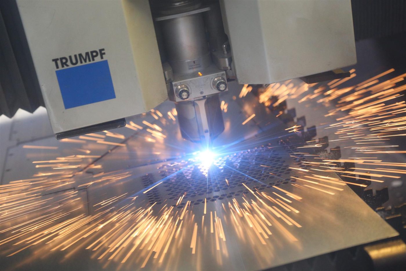 TRUMPF fibre laser cutting head with sparks during precision cutting